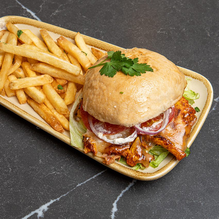A juicy chicken fillet with cheese, lettuce, tomato and your choice of lemon butter or peri-peri sauce. Served with chips from The Truro restaurant in South Croydon, london